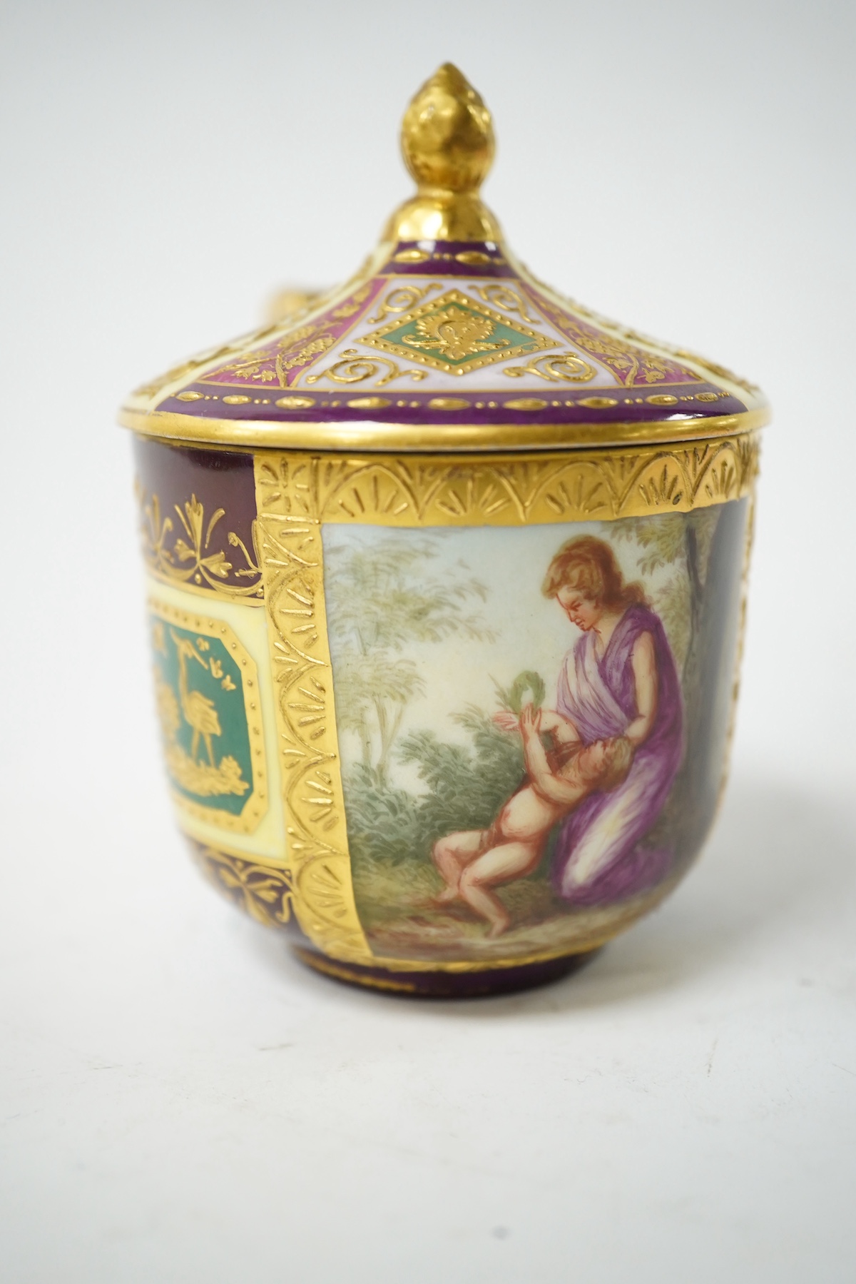 A late 19th century Vienna custard cup and saucer, outside and later decorated, beehive mark, 10cm high. Condition - good